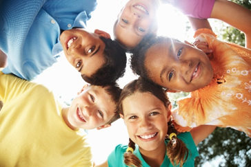 Young smiling kids in a huddle
